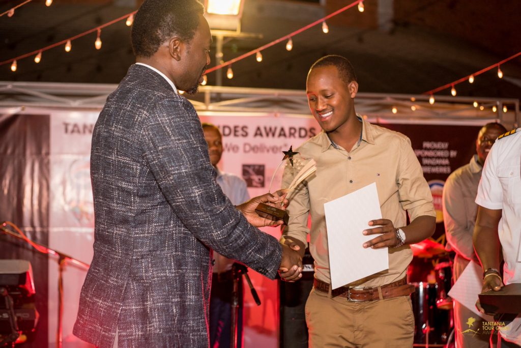An Asilia guide accepts an award | Asilia Africa