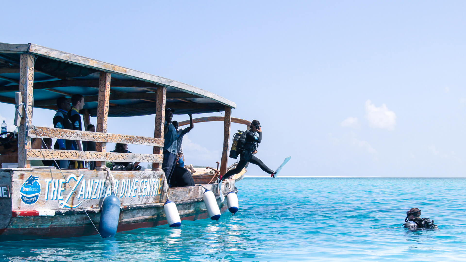 Scuba diver jumping off the boat in zanzibar