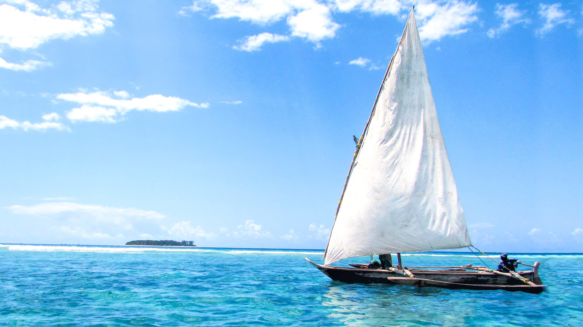Fisherman in a traditional sailing dhow on the northeast coast of Zanzibar