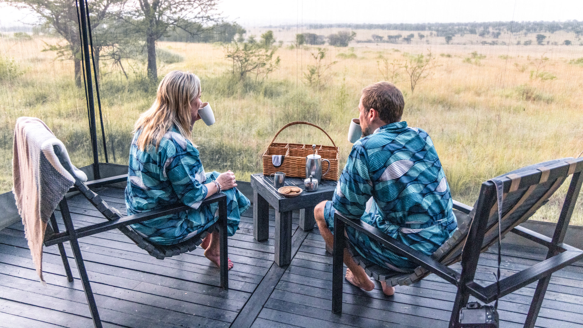 Serengeti National Park, guests in the morning, coffee, wake up call with biscuits, sitting on chairs with gowns