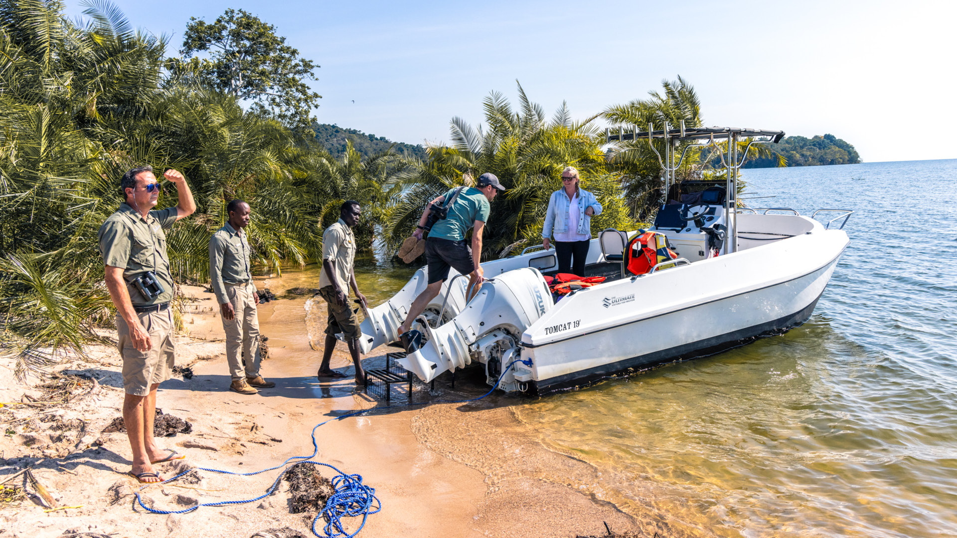 Lake Victoria, boat on shore as guests climb in for boating with guides