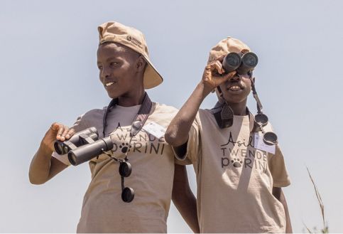 Two children with binoculars on an Asilia Africa Twende Porini trip at Rekero Camp in Tanzania