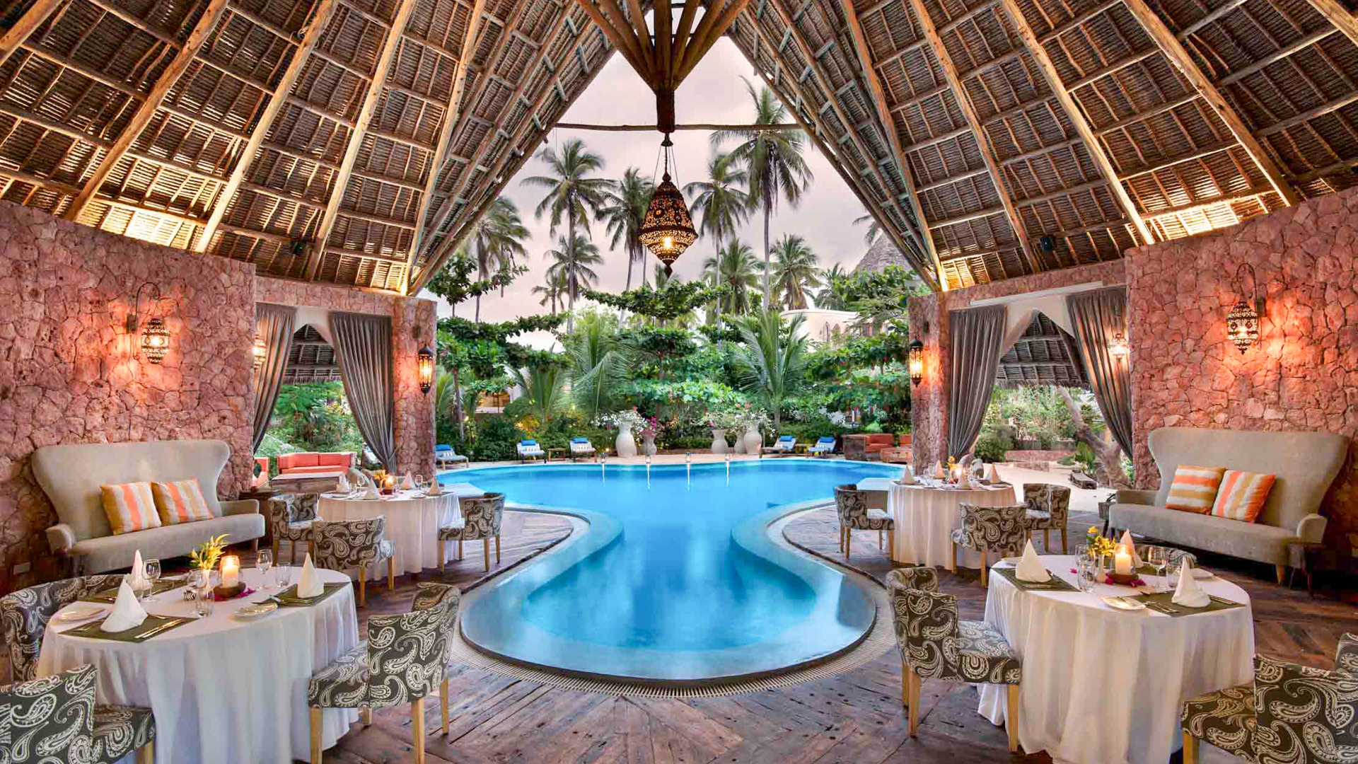 Dining tables set up around the pool in the Xanadu dining room