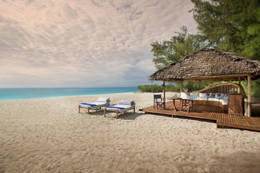 Sun loungers on an empty beach on Mnemba Island