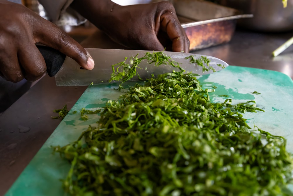 Fresh kale being prepped in the kitchen at Encounter Mara, Kenya.