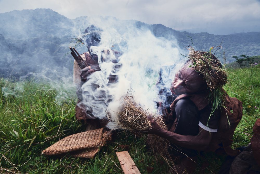 Preparing smoke ahead of the collection of honey, Bwindi, Uganda.