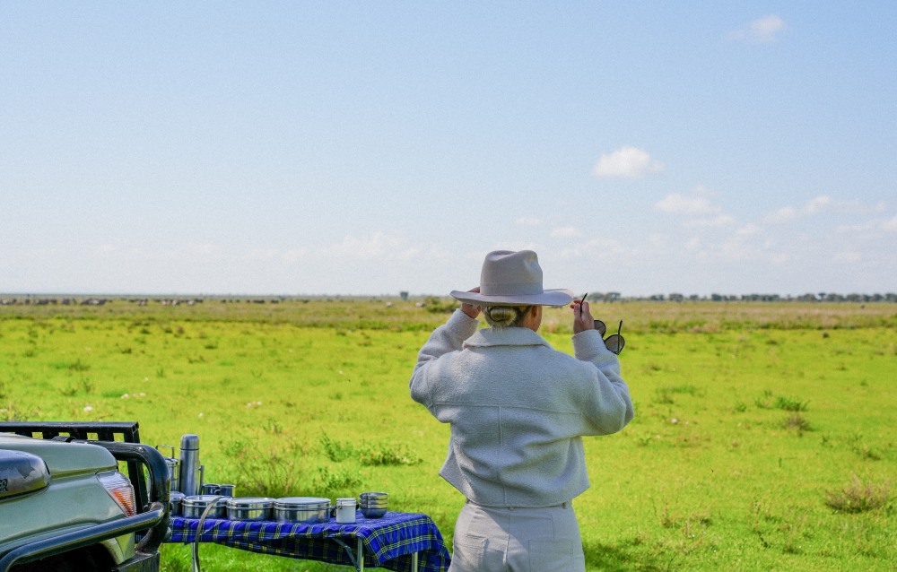 A guest with a wide brim hat and a pair of sunglasses, Tarangire National Park.