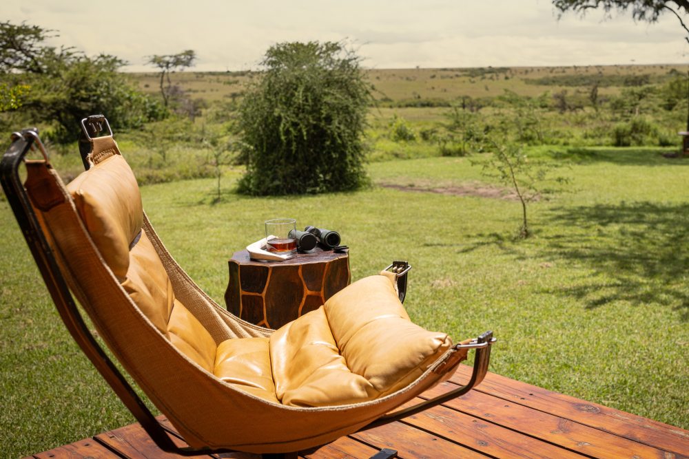Binoculars rest alongside a chair on the deck at Naboisho Camp, Kenya.