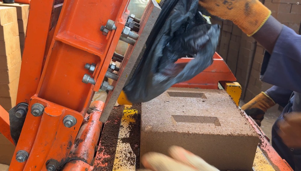 The creation of a CoolBrick through a compression process, Erebero Hills, Uganda.