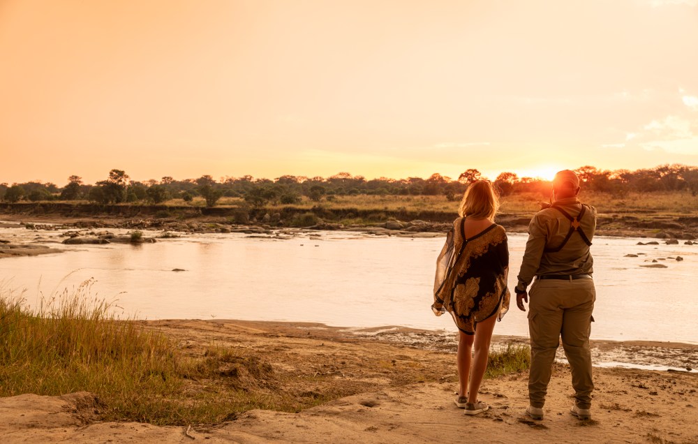 A guest and her guide at the Mara River, Serengeti, Tanzania.