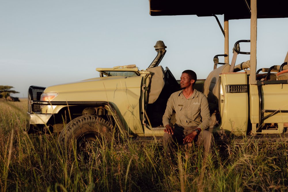Daniel and his safari vehicle, Namiri Plains, Tanzania