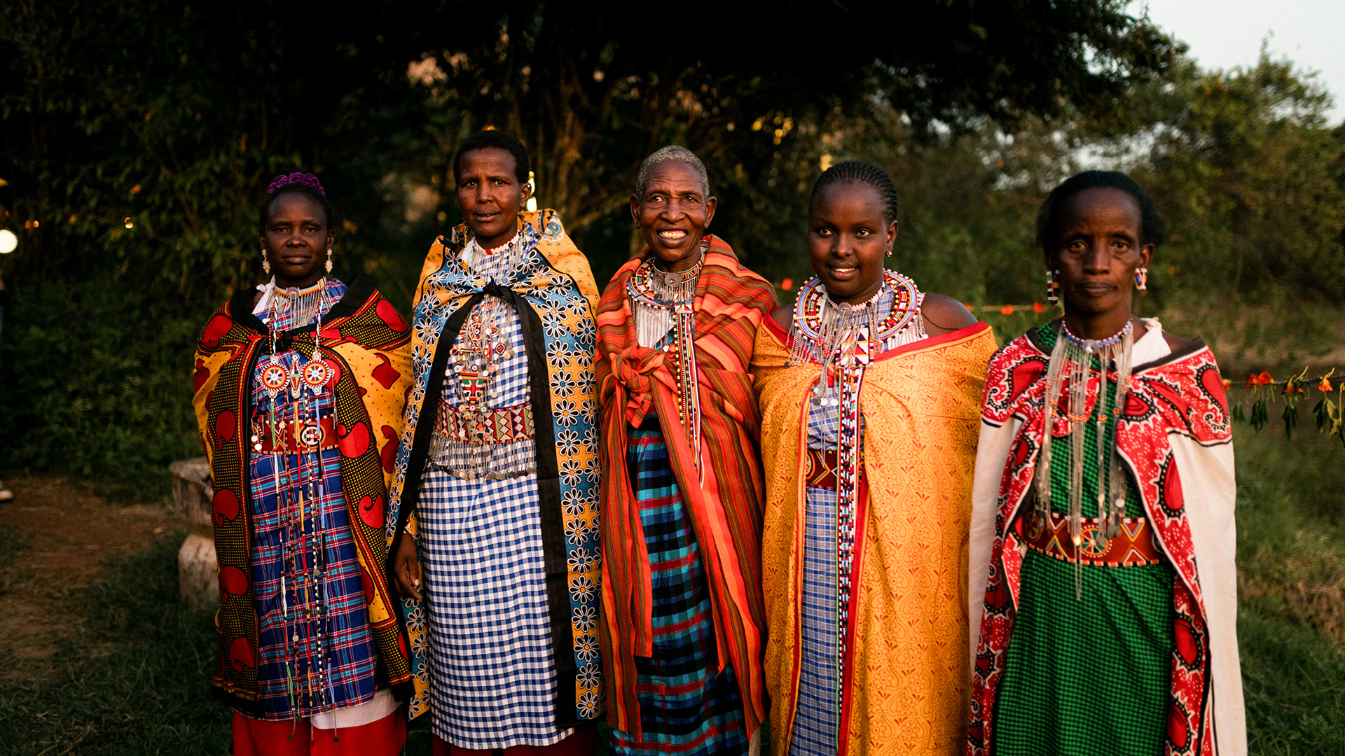 a group of ladies from the Maasai Mara community stand together