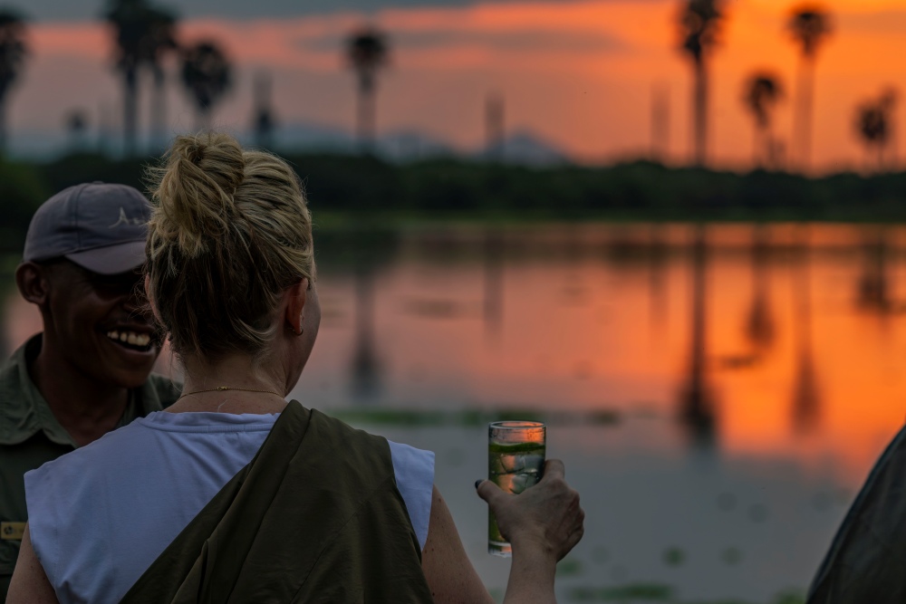 Sundowners alongside the water in Nyerere National Park, Tanzania.