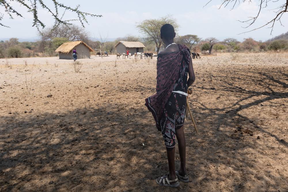 A Lion Defender visiting a herdsman, Ruaha National Park, Tanzania.