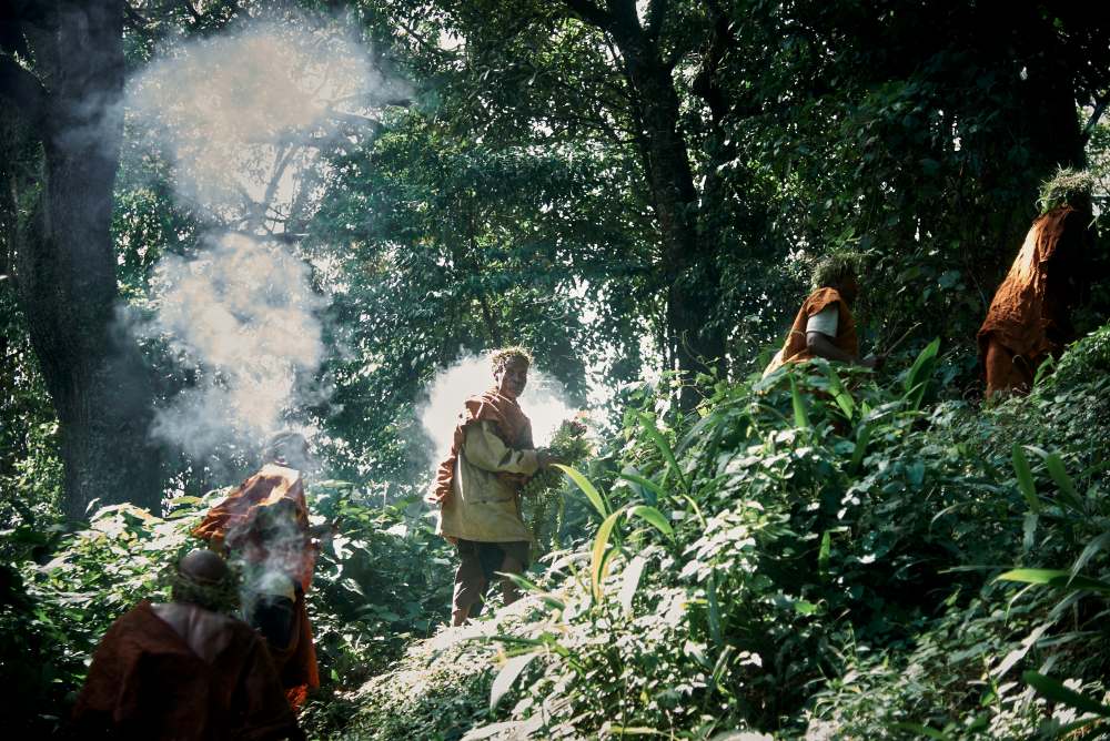 Batwa members in amongst the smoke in Bwindi Forest, Uganda