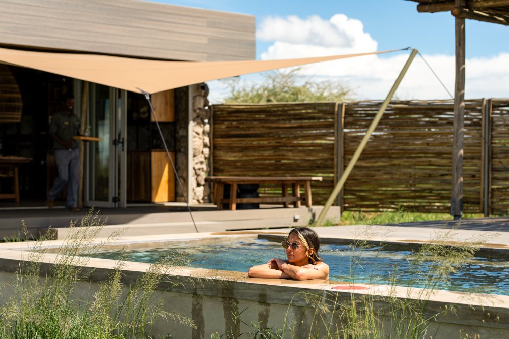 A guest enjoys the swimming pool at Namiri Reterats, Serengeti National Park, Tanzania.