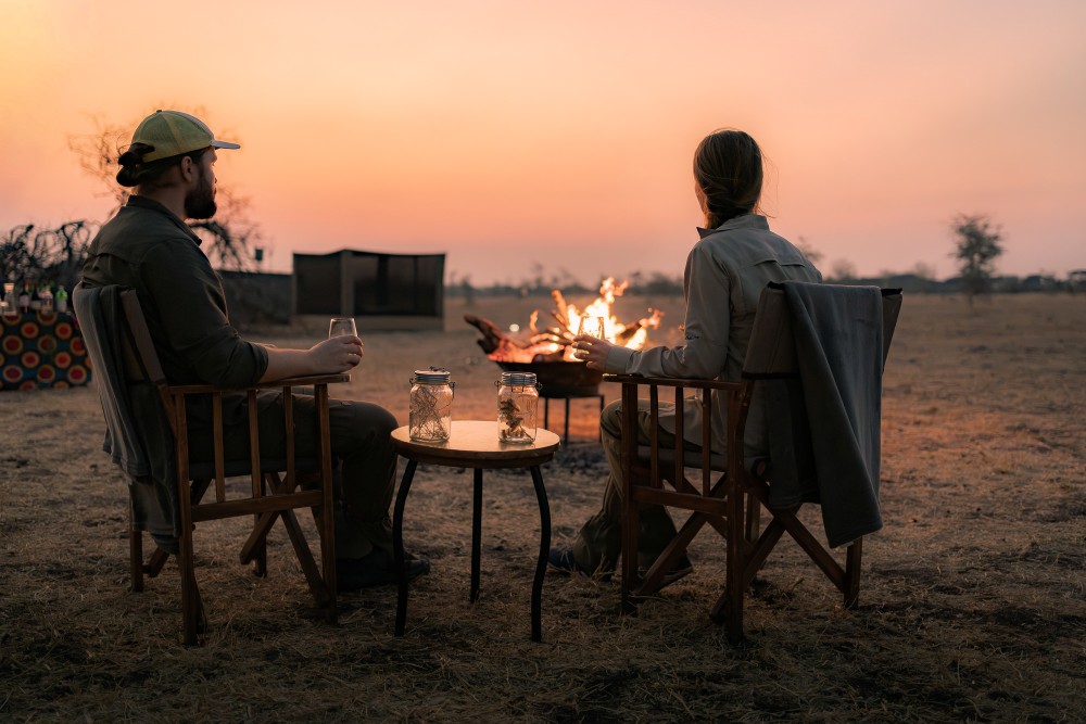 Drinks by the fire, Usangu Expedition Camp, Tanzania